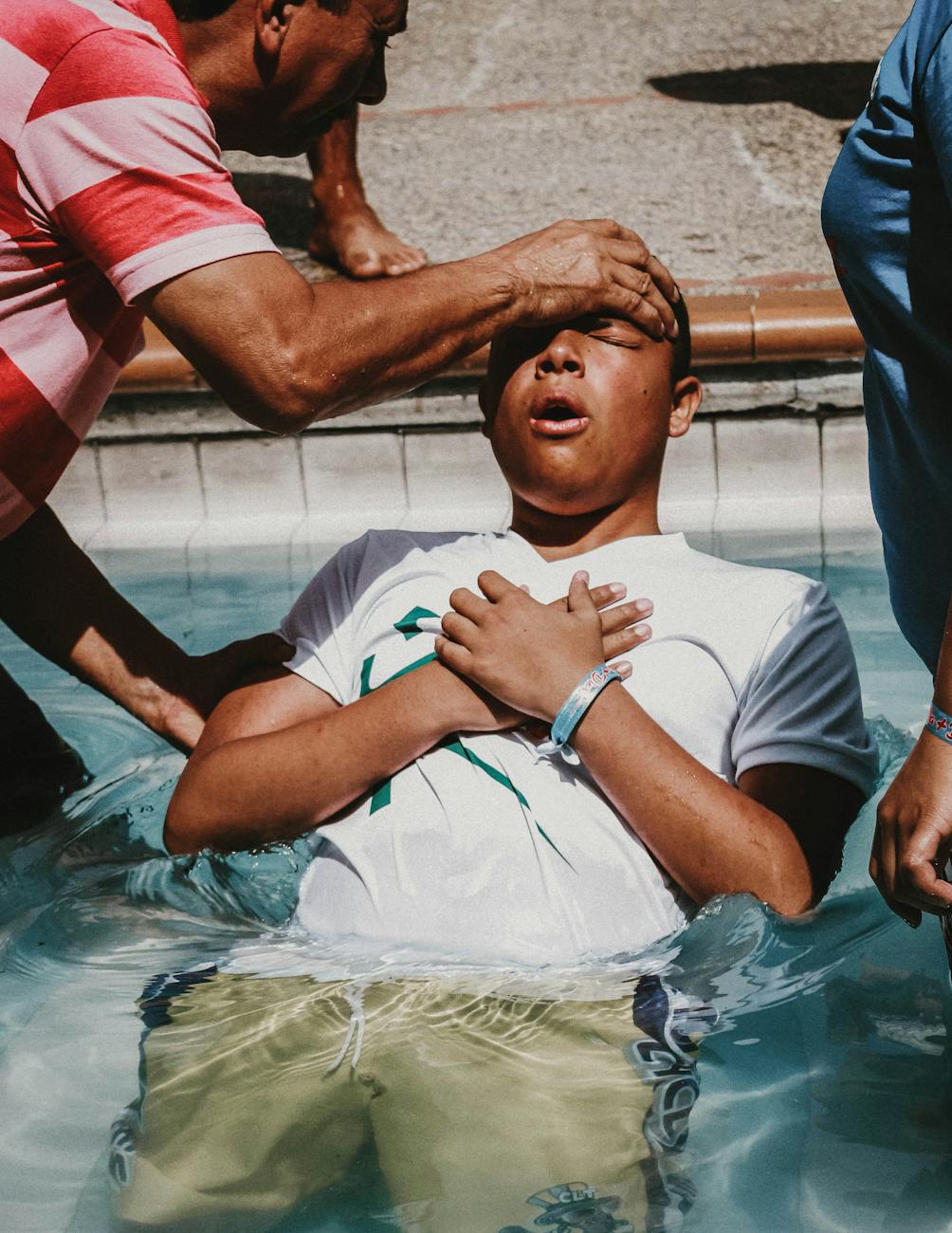 a man doing christian baptism on the water