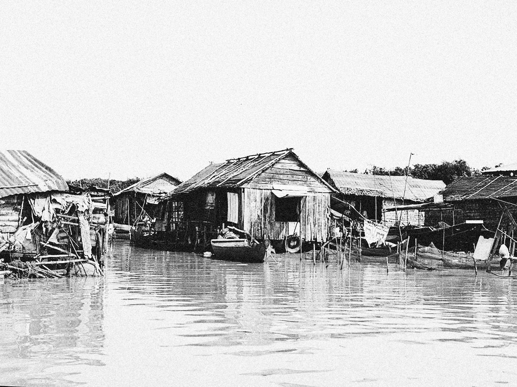 wooden houses with boats on water